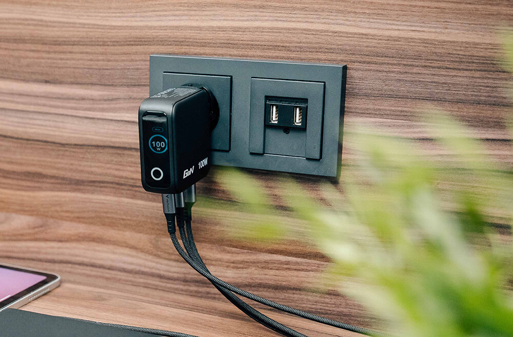 Mini GaN Charger with Display plugged into a socket showing 100W power on the display.