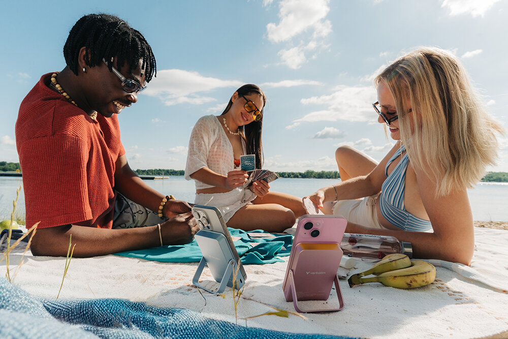 Friends playing cards on the beach in the summer